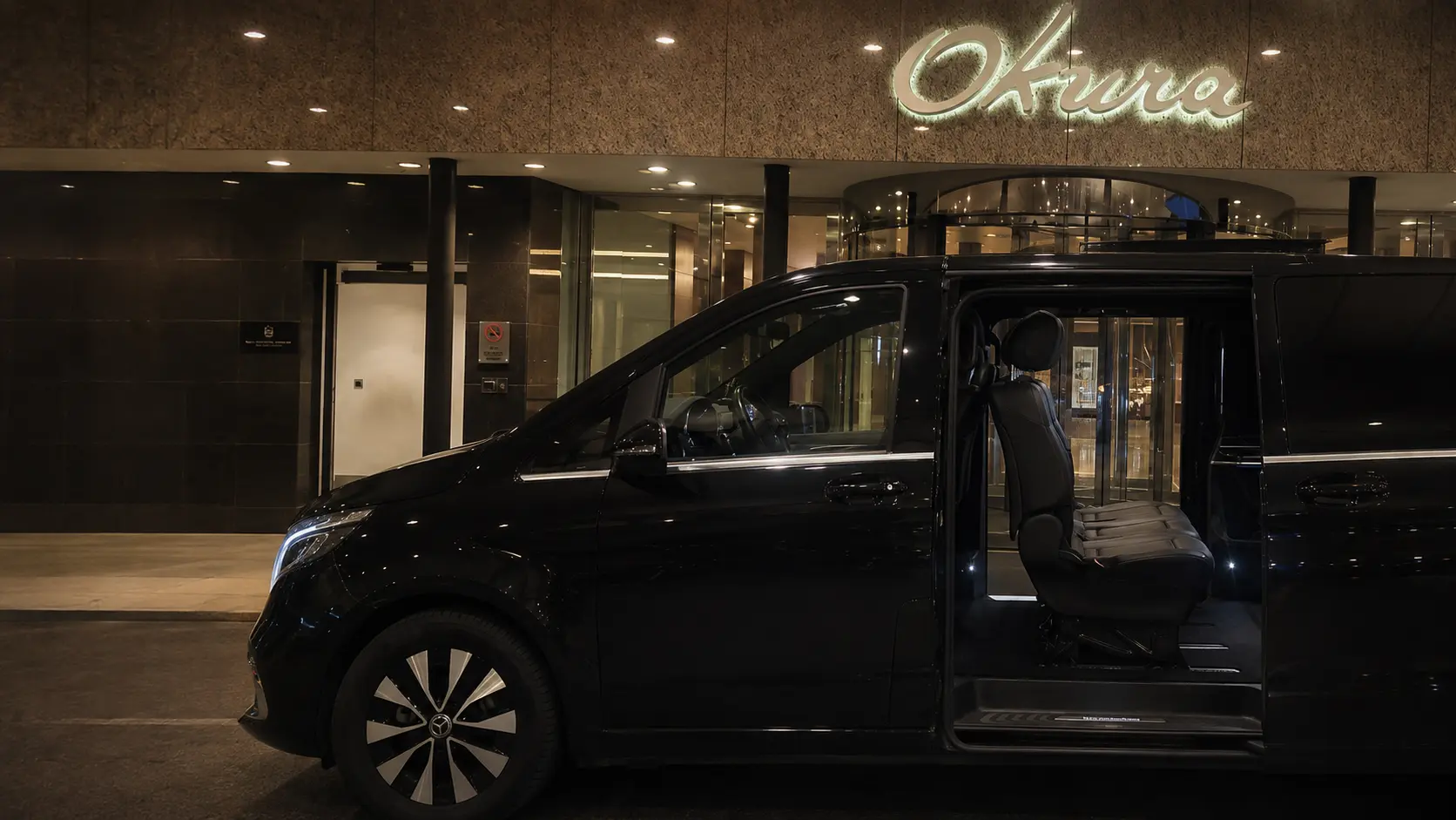 Reign Transportation Mercedes EQV with open passenger door at Hotel Okura Amsterdam
